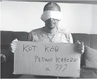  ?? GILBERT MIBRAMBEAU JR. / HO / THE CANADIAN PRESS ?? In a photograph posted to Twitter, Gilbert Mirambeau Jr. wears a blindfold and holds a sign written in Creole that reads: “Where is the PetroCarib­e money?”