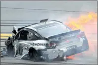  ?? AP/ GREG McWILLIAMS ?? Flames trail Danica Patrick’s vehicle after she was bumped by Michael McDowell before crashing into Matt Kenseth during Sunday’s race. Patrick hit the inside wall and had to have X- rays after sustaining bruises on her arms, legs and chest.