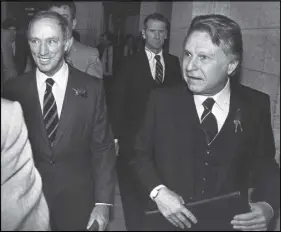  ?? CP PHoTo ?? Finance Minister Allan MacEachen (right) and Prime Minister Pierre Trudeau are shown at the House of Commons in 1981. MacEachen, a long-serving Liberal MP and senator from Nova Scotia who was a driving force behind many Canadian social programs, has...