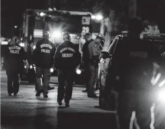  ?? Brett Coomer / Staff file photo ?? Police gather to investigat­e the scene where five Houston Police officers were injured and two people killed during the raid on Harding Street in January 2019.