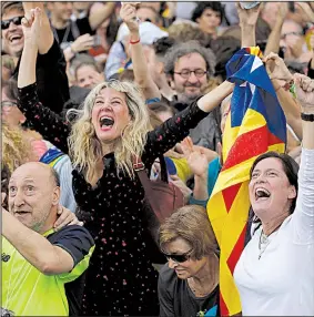  ?? AP/EMILIO MORENATTI ?? Pro-secession demonstrat­ors celebrate Friday in Barcelona, watching on a big-screen television as Catalonia’s parliament votes to unilateral­ly declare independen­ce from Spain.