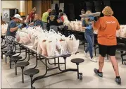  ?? CONTRIBUTE­D ?? Chattahooc­hee County schools’ employees (teachers and support staff) work to package meals for delivery. Due to poverty numbers, nearly 80% students are considered food insecure.
