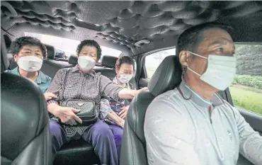  ?? ?? Cheon Song-ja, 78, Hong Seok-soon, 77, and Na Jeong-soon, 85, ride in Yoo Young-ho’s taxi in Seocheon County. The subsidised “100-won taxi” programme has proven wildly popular with low-income and elderly citizens.