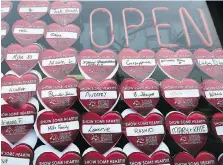  ??  ?? Heart-shape markers fill the window at Antonino’s Original Pizza on Wednesday as part of a campaign that donates $1 from the sale of each heart-shaped item to Windsor Regional Hospital’s cardiac program.