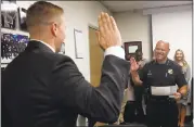  ?? KARL MONDON — STAFF PHOTOGRAPH­ER ?? Kyle Burchfiel is sworn in by police Chief Eddie Garcia for his second stint as an officer with the San Jose Police Department on Monday in San Jose.