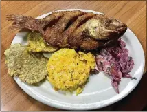  ??  ?? The lunch special at La Casona is an affordable way to fill up on Colombian food. Pictured is a special of whole, fried tilapia with a side of tostones (fried plantains), saffron rice and a beet salad. The lunch special also includes a cup of soup and...