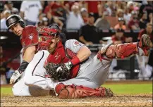  ?? CHRISTIAN PETERSEN / GETTY IMAGES ?? Reds catcher Tucker Barnhart tags out the Diamondbac­ks’ Paul Goldschmid­t at home as he tries to score from second base on a single to left in the sixth inning Sunday.