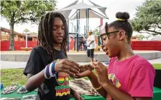  ?? Godofredo A. Vásquez / Staff photograph­er ?? Micah Nubin, 10, and his sister Hannah-Marie, 8, pet a snake Saturday at the Love Our Parks Fest at Our Park in Houston.
