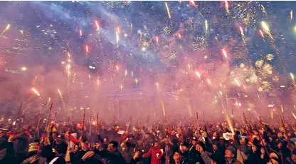  ??  ?? Protesters set off fireworks during a candleligh­t vigil calling for the arrest of impeached president Park Geun-hye in Seoul yesterday