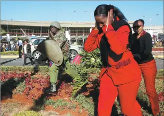  ?? THOMAS MUKOYA / REUTERS ?? Kenya Airways workers are dispersed by riot police officers at the Jomo Kenyatta Internatio­nal Airport during a labor dispute that grounded flights near Nairobi, Kenya, on Wednesday.