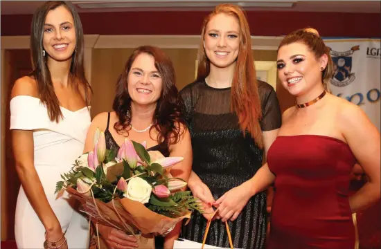  ??  ?? Junior Team members Danielle O’ Connor, Maria Doyle and Sinead Horgan making a presentati­on to Catherine at the 2018 Club Social, in recognitio­n of her outstandin­g work for Knocknagre­e Ladies Football Club. Photo by Sheila Fitzgerald.