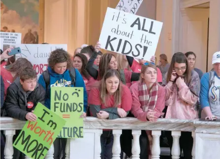  ?? — AFP ?? Kids join the teachers’ rally at the state capitol in Oklahoma City as Oklahoma becomes the latest state to be plagued by teacher strife.