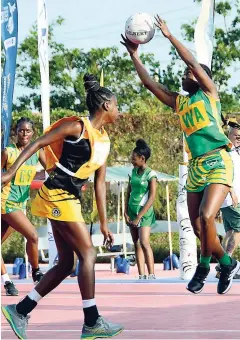  ?? LIONEL ROOKWOOD PHOTOS ?? Excelsior’s Latian Stewart (right) catches an aerial pass during their semifinal matchup of the AFNA Champions of Champions High School Netball Tournament held at the Leila Robinson Courts yesterday. Excelsior defeated Barbados’ Christ Church Foundation 61-42.