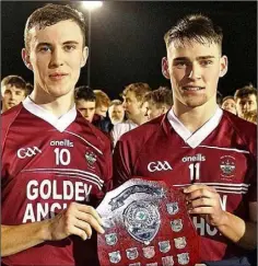  ??  ?? Joint captains Frank Roche and Robbie Brooks with the shield.