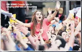  ??  ?? ON SONG Crowds join in singing after day of mourning