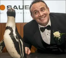  ?? Michael M. Santiago/Post-Gazette photos ?? Yarone Zober with a penguin.