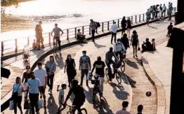  ?? MAXIME LA/THE NEW YORK TIMES ?? Bicyclists and pedestrian­s share a pathway in May along the Seine in Paris.