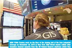  ??  ?? NEW YORK: Traders work on the floor at the closing bell of the Dow Industrial Average on November 28, 2018 in New York. Wall Street stocks rallied after investors cheered remarks from the US Federal Reserve chairman which they viewed as a sign interest rates may not rise much further. —AFP