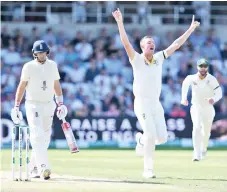  ??  ?? Australia's Josh Hazlewood (C) celebrates taking the wicket of England's captain Joe Root (L) for 0 runs on the second day of the third Ashes cricket Test match. - AFP photo