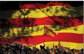  ?? AP/GONZALO ARROYO ?? Spanish nationalis­ts hold a rally against independen­ce for Catalonia on Sunday in Barcelona. Hundreds of thousands of Catalans joined the protest, which took place in a festive atmosphere.