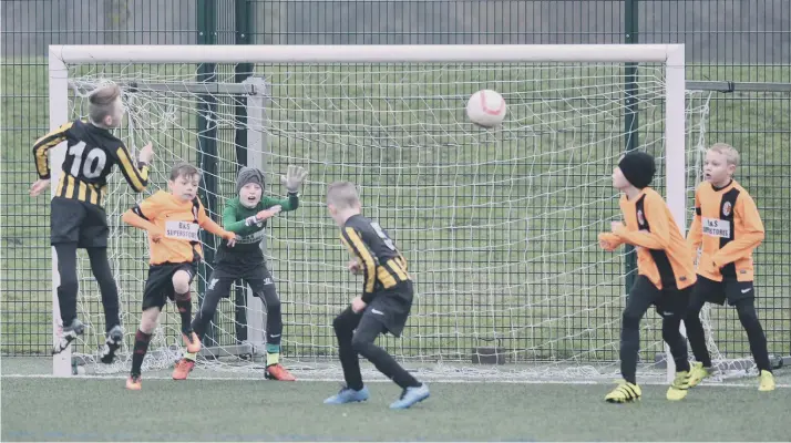  ??  ?? Russell Foster Mini Soccer Under-10s Winter League action between Dubmire Milan (orange) and Whitburn & Cleadon, played at Riverside, Chester-le-Street.