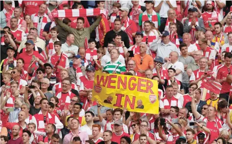  ?? — Reuters ?? Arsenal fans hold up a “Wenger In” banner at the end of the FA Cup final.