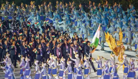  ?? — PTI, AFP ?? ABOVE: Javelin thrower Neeraj Chopra bears the tricolour as he leads the Indian contingent at Gelora Bung Karno Stadium during the opening ceremony in Jakarta on Saturday. BELOW: Fireworks explode over the Gelora Bung Karno main stadium