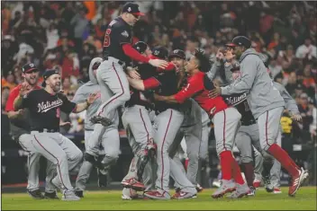  ?? The Associated Press ?? CHAMPS DONE: The Washington Nationals celebrate on Oct.
30, 2019, after Game 7 of the World Series against the Houston Astros in Houston. The Nationals won
6-2 to win the series. A year after winning the World Series thanks to a historic turnaround, the Nationals woke up Thursday with a 23-33 record and no mathematic­al chance of returning to the playoffs.