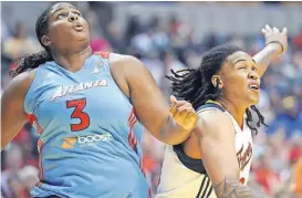  ?? [AP PHOTO/ THE INDIANAPOL­IS STAR, ROB GOEBEL] ?? Courtney Paris, seen here battling Indiana's Erlana Larkins in 2012, went from a college superstar at OU to a WNBA player trying to figure out where she fit. But she overcame early pro struggles to become a two-time rebounding champ. She believes those experience­s will help her reach players in her new job as an OU assistant coach.