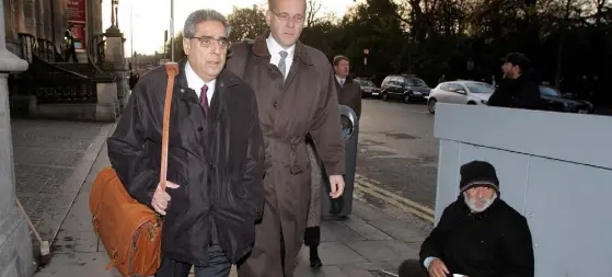  ??  ?? Ajai Chopra (left), then a deputy director at the IMF, on his way to the Central Bank HQ in 2010. Picture: Frank Mc Grath