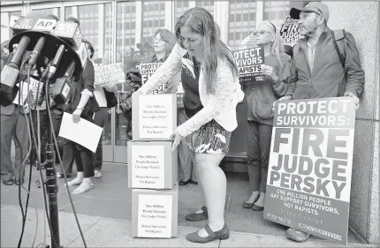  ?? ERIC RISBERG / ASSOCIATED PRESS ?? An activist from UltraViole­t, a national women’s advocacy organizati­on, submits signatures to the California Commission on Judicial Performanc­e calling for the removal of Judge Aaron Persky from the bench during a rally Friday in San Francisco.