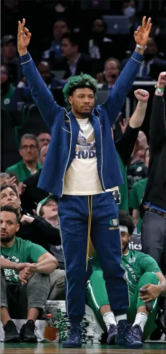  ?? STUART CAHILL / HERALD STAFF ?? NEARING RETURN: Celtics guard Marcus Smart cheers on his team against the Bucks in Game 2 of the Eastern Conference Semifinals at TD Garden on Tuesday.