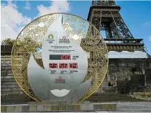  ?? AFP-Yonhap ?? A countdown clock for the Paris 2024 Olympic Games indicates 100 days before the opening ceremony in front of the Eiffel Tower in Paris, Tuesday.