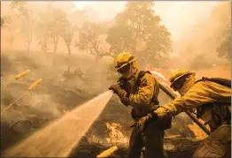  ?? Photo for The Washington Post by Stuart W. Palley ?? Firefighte­rs worked to extinguish flames as the River Fire advanced toward structures west of Lakeport, Calif., on Tuesday.