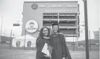  ?? KASSI JACKSON/HARTFORD COURANT ?? First-generation college graduates Nadeige Bailey, left, who earned a master’s degree in sport management, and Kimberly Duhart, with a master’s in education, stand together for a photo before the ceremony.