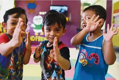  ??  ?? Safe and sound: Children at the Pekan Hospital childcare centre having fun while their parents are kept updated on their activities via WhatsApp.