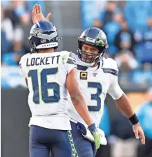  ?? GETTY IMAGES ?? Russell Wilson and Tyler Lockett helped Seattle move into the top playoff spot in the NFC on Sunday with two weeks to play.