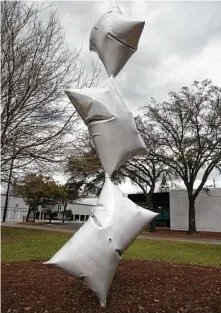  ??  ?? William Cannings’ “Stacked Pillows” sculpture seems to take flight along Heights Boulevard.