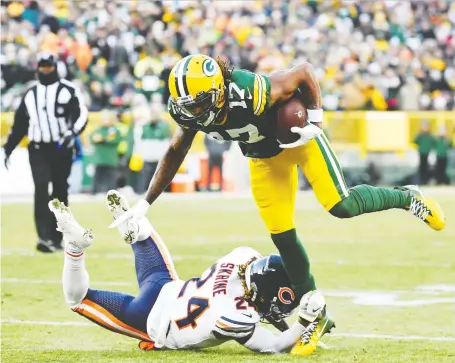  ?? QUINN HARRIS/GETTY IMAGES ?? Davante Adams had a big day for the Packers Sunday against Buster Skrine and the visiting Chicago Bears, hauling in seven passes for 103 yards and a touchdown in a 21-13 victory in Green Bay, Wis.