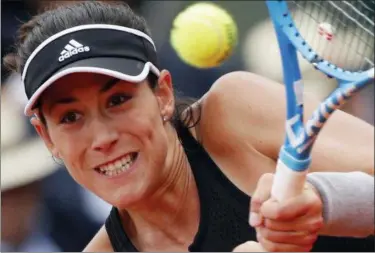  ?? CHRISTOPHE ENA — THE ASSOCIATED PRESS ?? Garbine Muguruza returns a shot against Maria Sharapova during their quarterfin­al match at the French Open at the Roland Garros stadium in Paris, France, Wednesday.