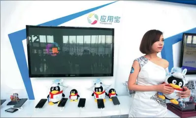  ?? PROVIDED TO CHINA DAILY ?? Tencent’s stall at the 2014 Global Mobile Internet Conference in Beijing displays QQ’s mascots. Teenagers in China are moving away from text-based online content and TV to video and social media such as QQ, the Chinese-language instant messenger.