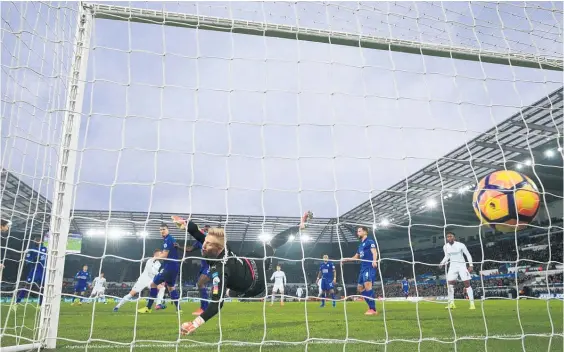  ?? Picture / AP ?? Swansea City’s Alfie Mawson (left) scores his side’s first goal in their English Premier League match against Leicester.