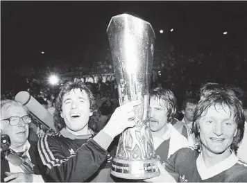  ??  ?? Paul Cooper, left, gets his hands on the UEFA Cup after Ipswich beat AZ Alkmaar in 1981