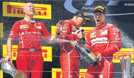  ?? AFP ?? (From right) Winner Sebastian Vettel celebrates with Ferrari teammate Kimi Raikkonen and team engineer Jock Clear too soaks it all in.