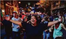  ?? AP ?? A protester gestures while marching down Church Street with other demonstrat­ors to protest Tuesday’s fatal police shooting of Keith Lamont Scott, during a march through the streets of Charlotte, North Carolina, Friday.