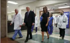  ??  ?? President Donald Trump and first lady Melania Trump walk with surgeon Dr. John Fildes (left), at the University Medical Center on Wednesday after meeting with survivors of the mass shooting in Las Vegas. AP PHOTO/EVAN VUCCI