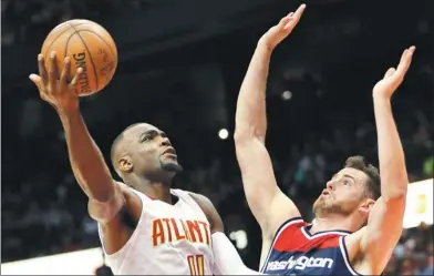  ?? AP FILE ?? Atlanta Hawks forward Paul Millsap shoots against Washington Wizards forward Jason Smith during an April playoff game in Atlanta. Millsap has agreed to terms with the Denver Nuggets on a three-year deal worth $90 million.
