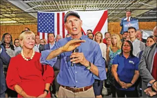  ?? RED HUBER / ORLANDO SENTINEL ?? Gov. Rick Scott (center), next to his wife, Ann (left), launches his campaign for the U.S. Senate on Monday at the ODC Constructi­on company in Orlando. Scott railed against “career politician­s” and said Washington needs fresh ideas. “We can change...