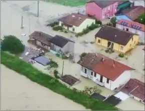  ?? The Associated Press ?? This aerial photo provided by the Italian Firefighte­rs shows flooded houses in Cesena, in northern Italy on Tuesday. Unusually heavy rains have caused major flooding in the region, where trains were stopped and schools closed.