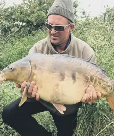  ??  ?? Angus Nicholls with his 28lb 5oz River Nene carp.